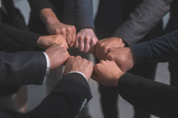 istock close up . business team showing their unity 1356055723