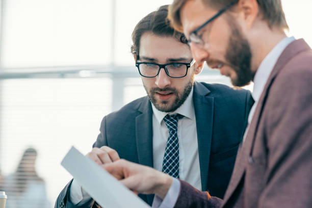 istock close up. two employees discussing a legal document 1356055779