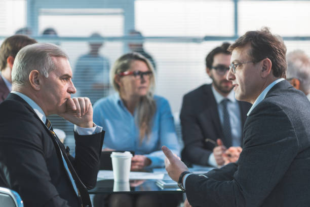 serious business people discuss problems at a work meeting stock photo