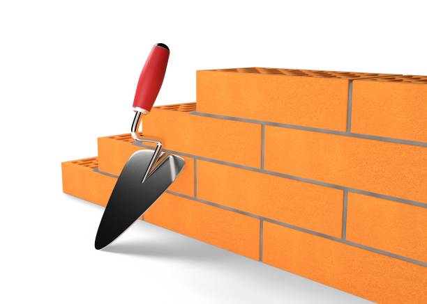 istock 3d render illustration clay bricks and cement trowel isolated on white background. Realistic new red perforated ceramic bricks and metal spatula. Clay bricks for house and wall construction. Building. 1356057918