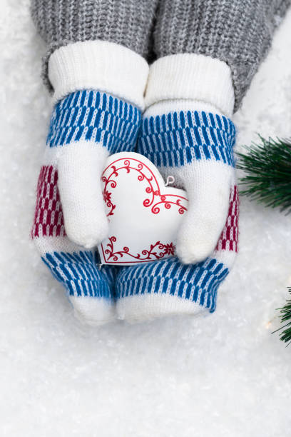 istock Selective focus on woman wearing knitted ornamental mittens 1356058753