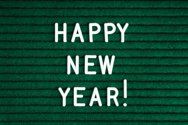 Happy new year , text on green felt letter board with white letters