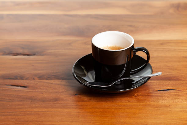 istock Black espresso cup with spoon on wooden table 1356060164