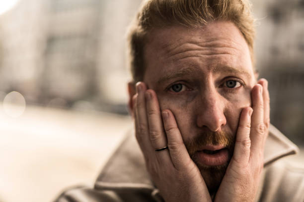 istock Depressed young man in the city. 1356060415
