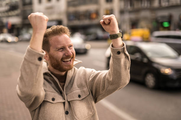 istock Ecstatic young man walking in the city. 1356060440