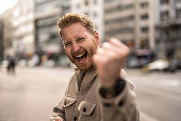 istock Ecstatic young man in the city looking at camera. 1356060950