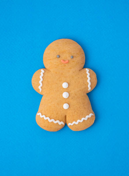 istock gingerbread man on blue paper background 1356062666