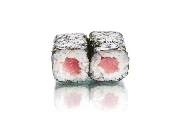 istock Two pieces of Maki sushi roll with tuna isolated on white background with reflection 1356063628