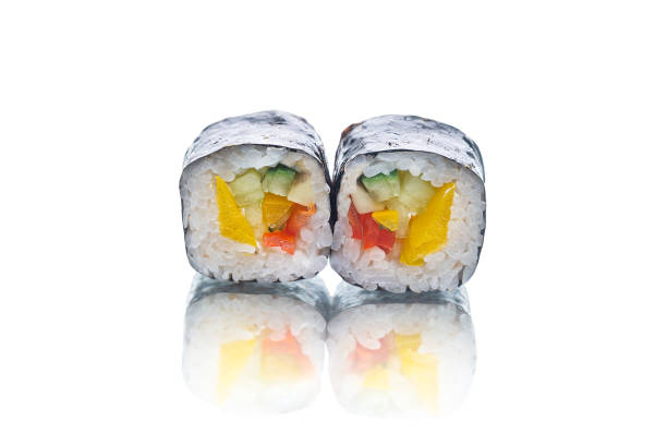 Two pieces of Maki sushi roll with vegetables isolated on white background with reflection