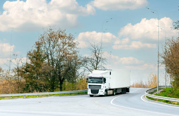 istock White truck with cargo on the turn on the track 1356064714