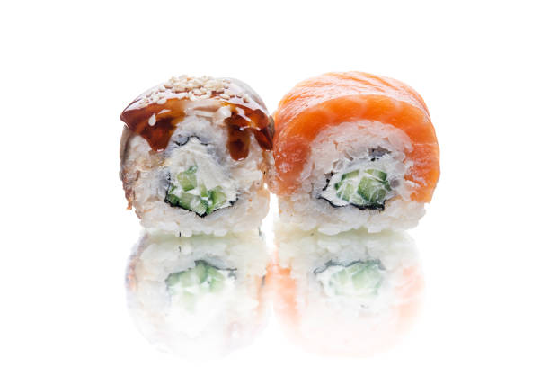 istock Two pieces of Maki sushi roll with unagi eel isolated on white background 1356064780