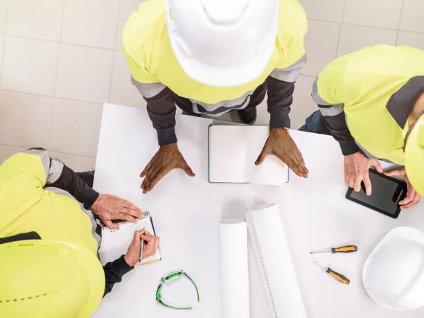 istock Top view of a group of a multiethnic people at work wearing helmets. Selective focus 1356065624