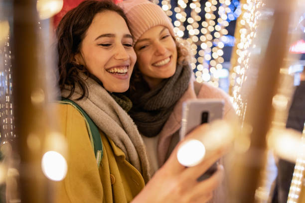 istock Two woman outdoors during winter, looking at the phone 1356065649