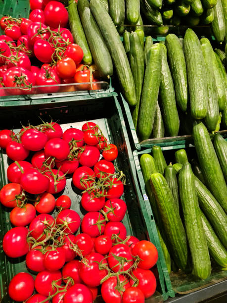 istock Tomatoes and cucumbers ready for sale in a supermarket. 1356073064