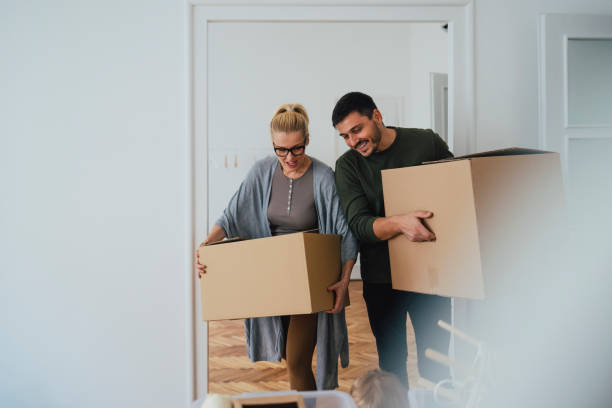 istock Man and Woman Carrying Boxes 1356074092