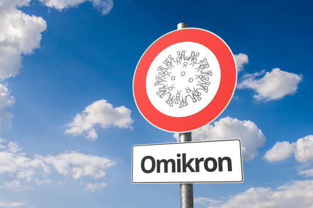 New mutation of corona virus named "omikron" B.1.1.529: Corona virus - Schematic image of a virus on a no entry sign with the the text "Omikron" below. stock photo