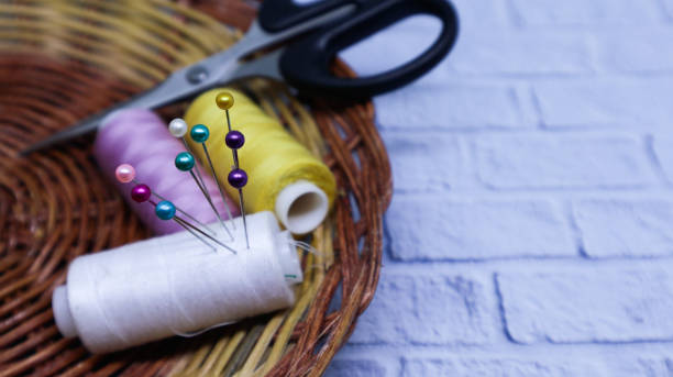 istock Sewing equipment, thread, scissors and needle on a rattan holder 1356076341