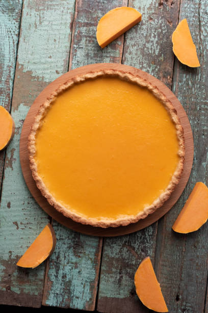 istock Pumpkin pie with pumpkin slices on old painted surface 1356076362