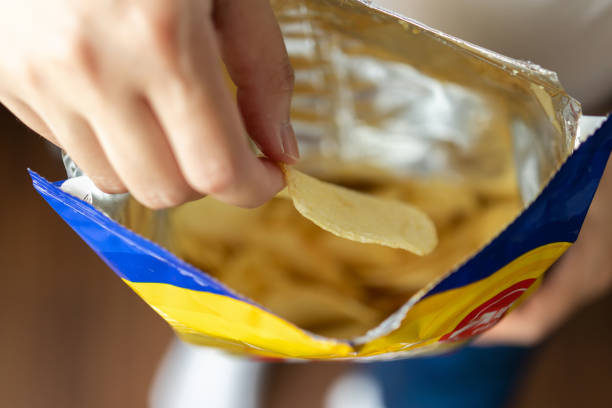 istock Hand hold potato chips with snack bag 1356078274