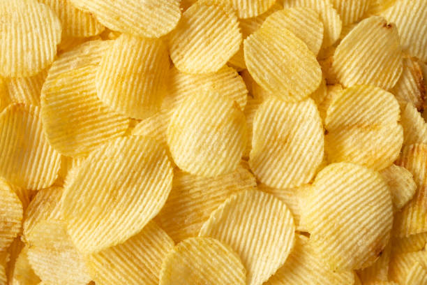 istock crispy golden potato chips snack texture background 1356078277