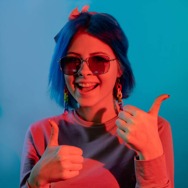 istock thumbs up gesture approval sign neon light woman 1356078554
