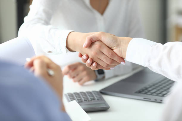 istock Female partners handshaking 1356078717