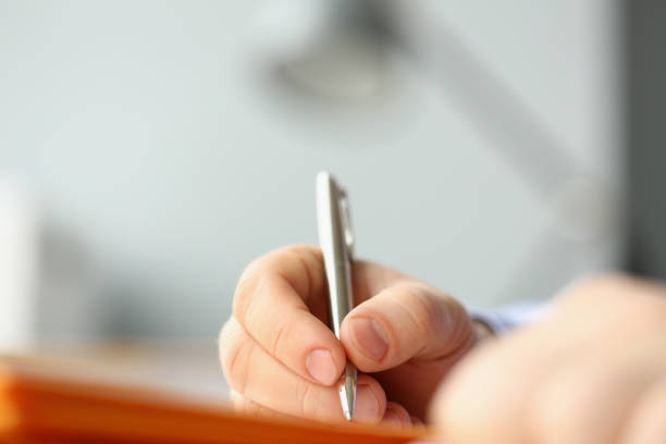istock Professional businessman writing his idea in notebook with silver pen 1356078789