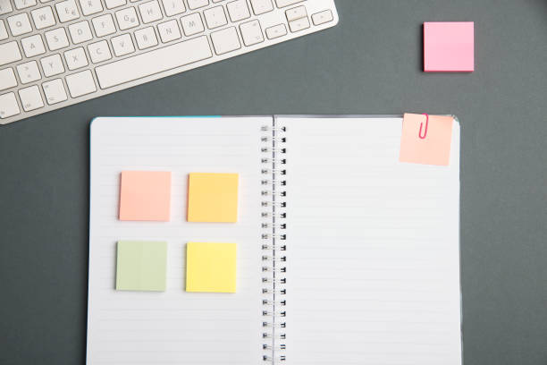 istock Keyboard Over A Table Beside A Notebook And Pens With Sticky Notes. Computer Keypad On Top Of A Desk With A Office Supplies And Desk Photo.. 1356079299