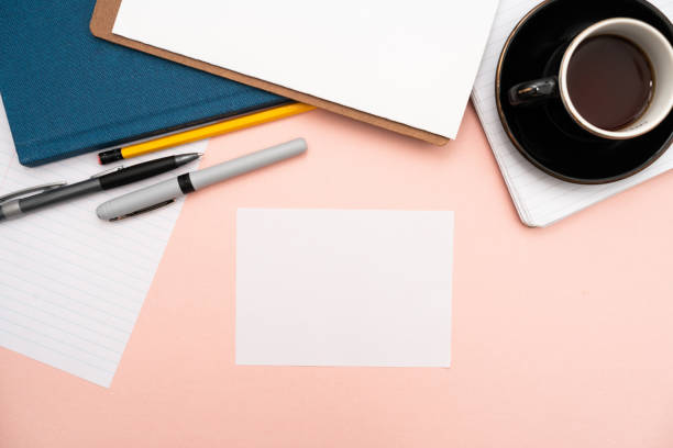 istock Office Supplies Over Desk With Keyboard And Glasses And Coffee Cup For Working Remotely, Assorted School Utilities For Studying With Hot Drink And Eyeglasses. 1356079341