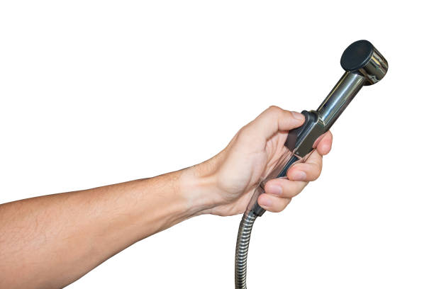 istock hand holding bidet sprayer isolated on white background 1356084231