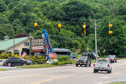 Banner Elk, USA - June 23, 2021: Downtown Banner Elk in North Carolina city town with sign for Sugar creek gem jewelry mine near Beech Mountain ski resort with road street
