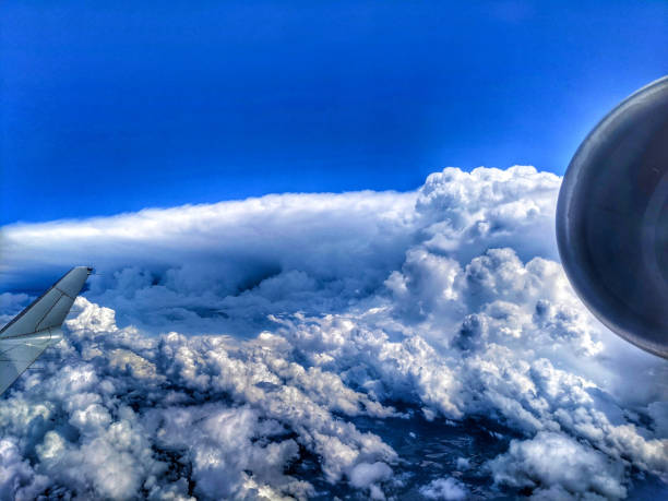 View of blue cloudy sky from airplane window