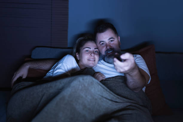 istock Couple watching movie at home 1356089685