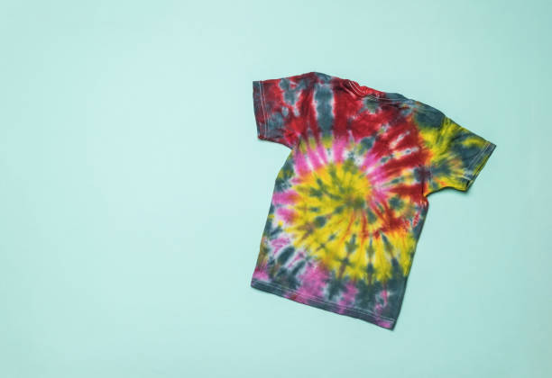 istock Stylish tie dye T-shirt on a light blue background. Flat lay. 1356093373