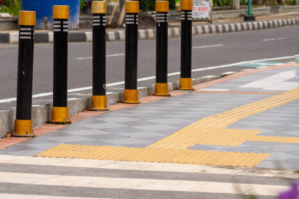 istock The sidewalk next to the highway is equipped with a path for people with disabilities in yellow 1356093458