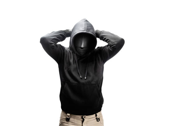 A criminal man in a hidden mask raised a hand behind the head for arrested isolated over white background