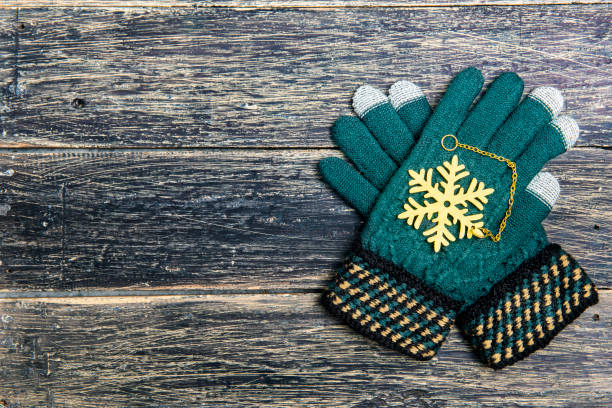 istock Winter gloves on wooden background 1356104813