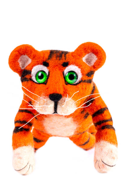 istock Orange tiger cub from natural felted wool on a white background 1356105117