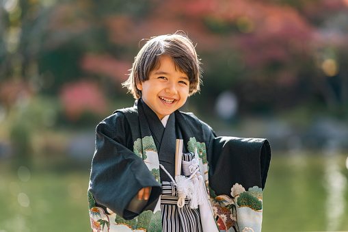 A portrait of a small multi-raced Eurasian ethnic Japanese boy dresses in Japanese traditional clothing hakama for Japanese traditional celebration called Shichi go san.