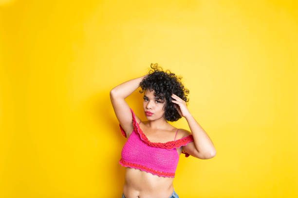 istock Young cheerful ethnic woman holding her curls 1356108584
