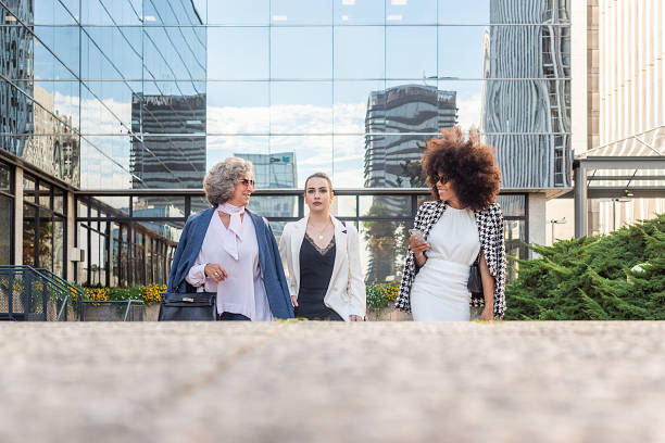 istock three business women leaving work talking to each other 1356109517