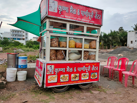 Papri chat, bhel puri and wide variety of chats being sold by a fast food vendor in his stall beside a road Phaltan, Maharashtra, India August, 16, 2021