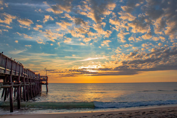istock Sunrise at the Sandbridge beach pier 1356112233