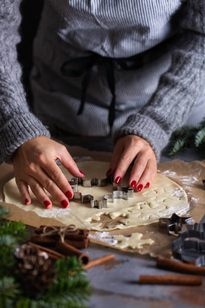 istock Christmas cooking and baking, female hands making cookies from dough 1356116668