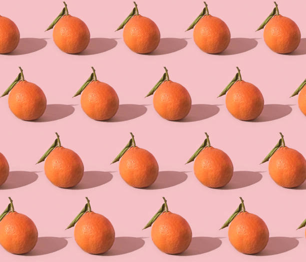 istock Fruit pattern of fresh tangerine on pink background 1356116725