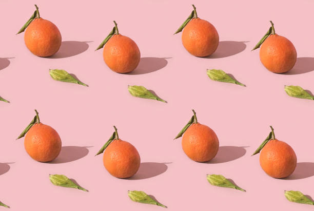 istock Fruit seamless pattern of fresh tangerine on pink background 1356116782