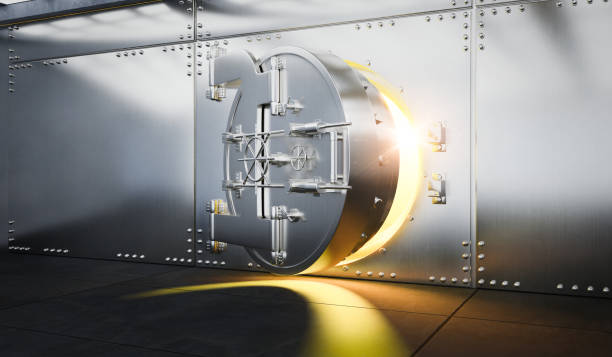 istock Open Bank vault door with gold light comes out from inside 1356117712