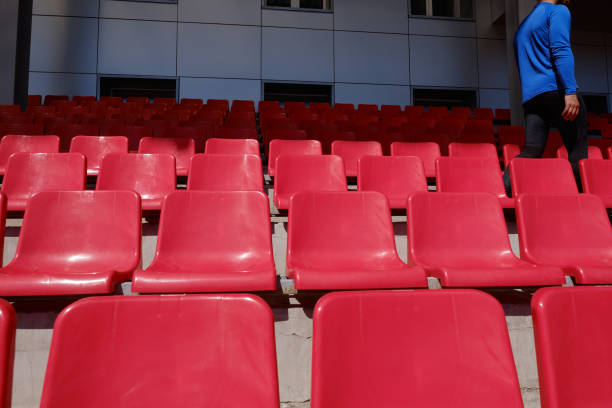 istock Sportsman walking stadium along rows 1356118592