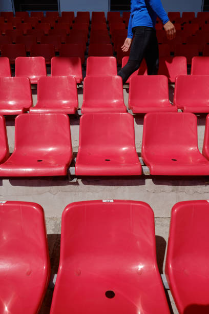 istock Sportsman walking stadium along rows 1356118598