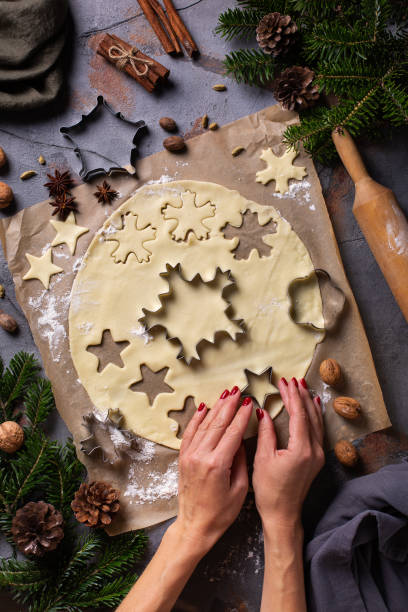istock Christmas cooking and baking, female hands making cookies from dough 1356119267